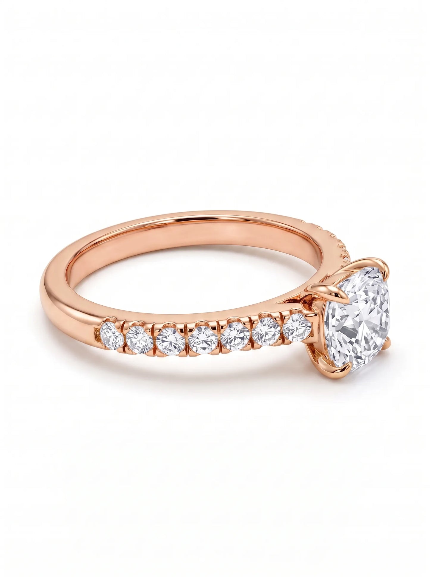 Cushion cut lab grown diamond engagement ring featuring a 1.03 carat center diamond in a four-prong setting with round accent diamonds on a rose gold design.