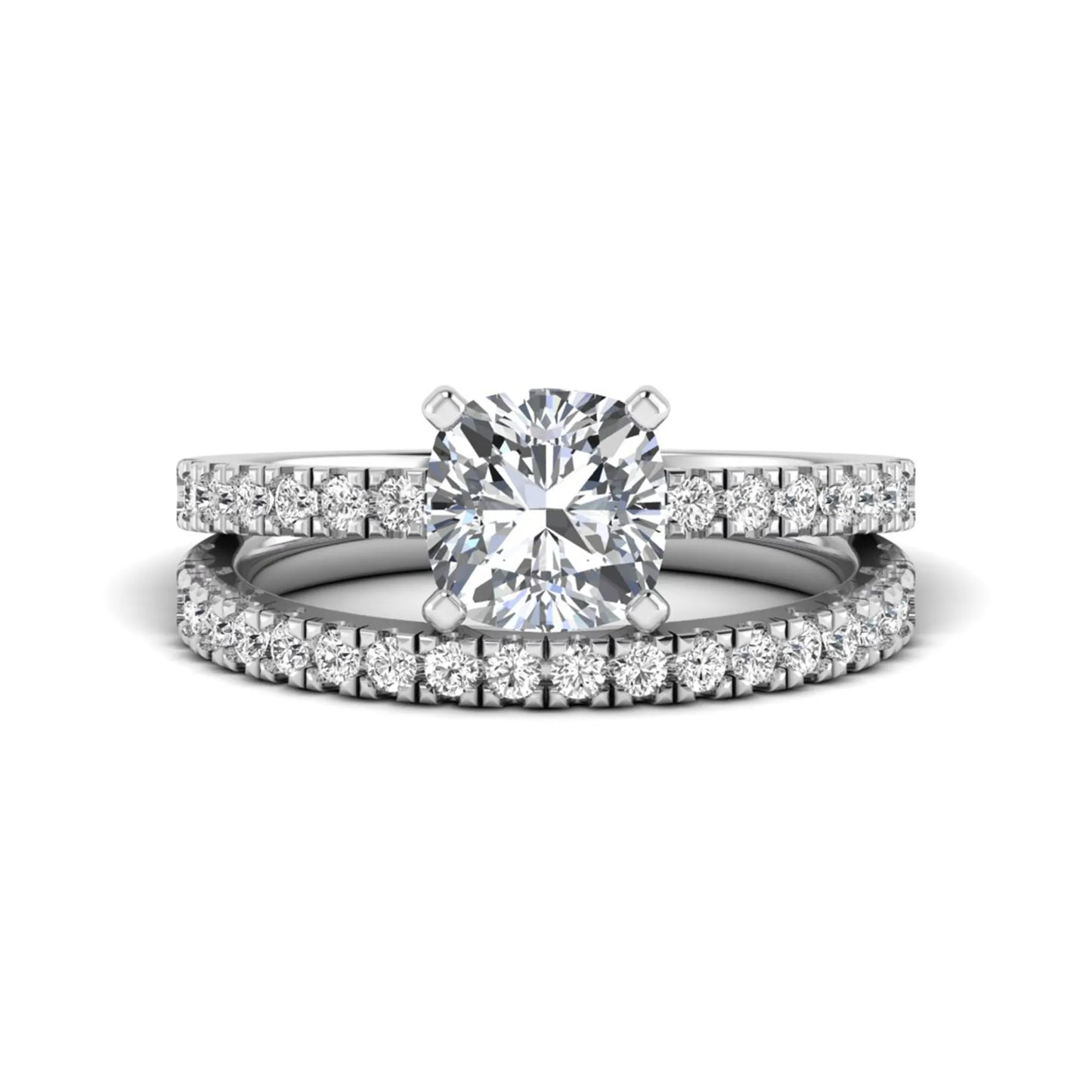 Cushion cut lab grown diamond bridal ring set featuring a four-prong solitaire engagement ring with a matching pavé diamond wedding band in a white gold tone design.
