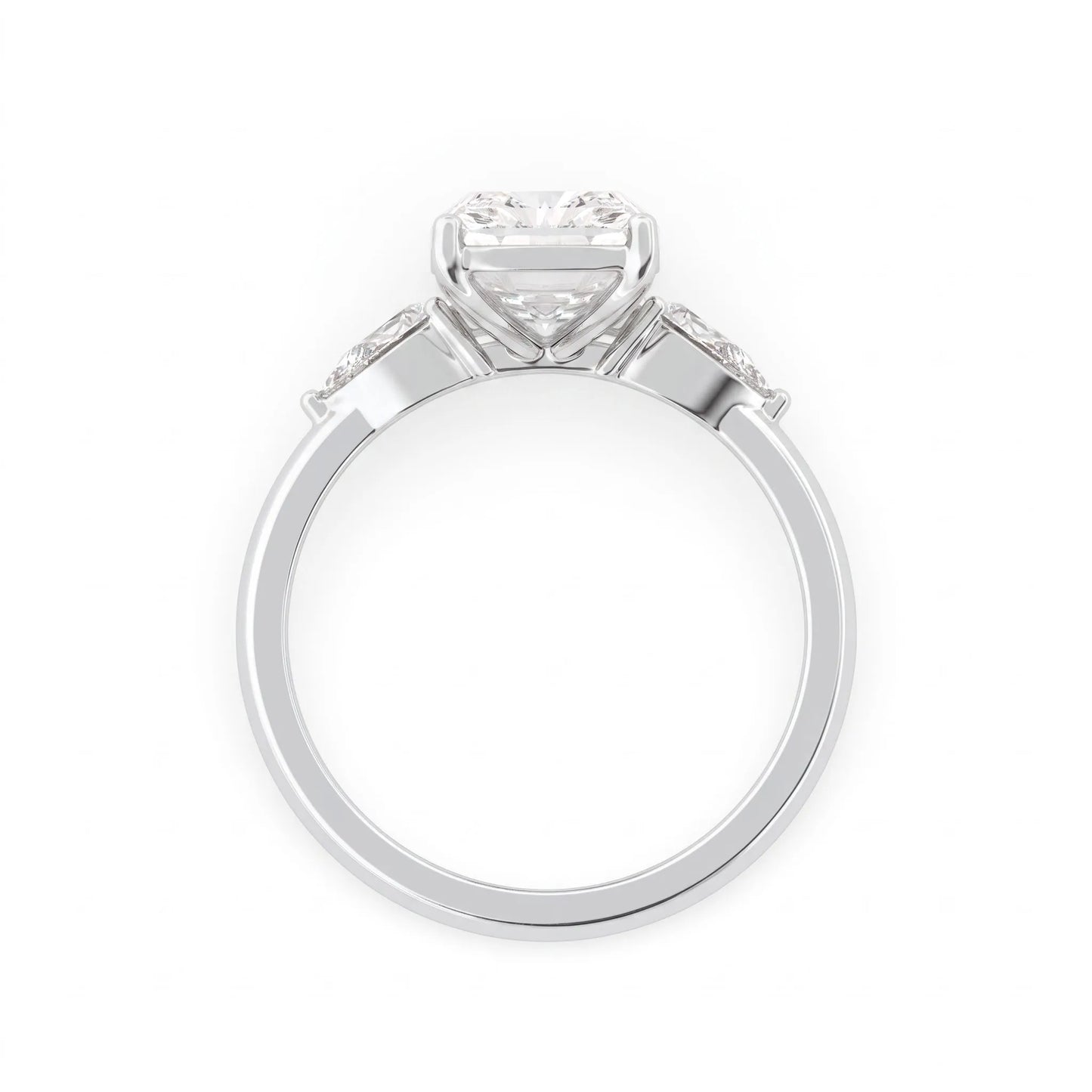 Elongated cushion cut lab grown diamond three stone engagement ring featuring pear cut side diamonds in a four-prong setting with a polished white gold tone band.