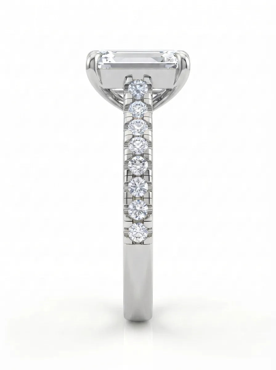 Emerald cut lab grown diamond engagement ring with pavé round diamonds in a white gold four-prong cathedral setting