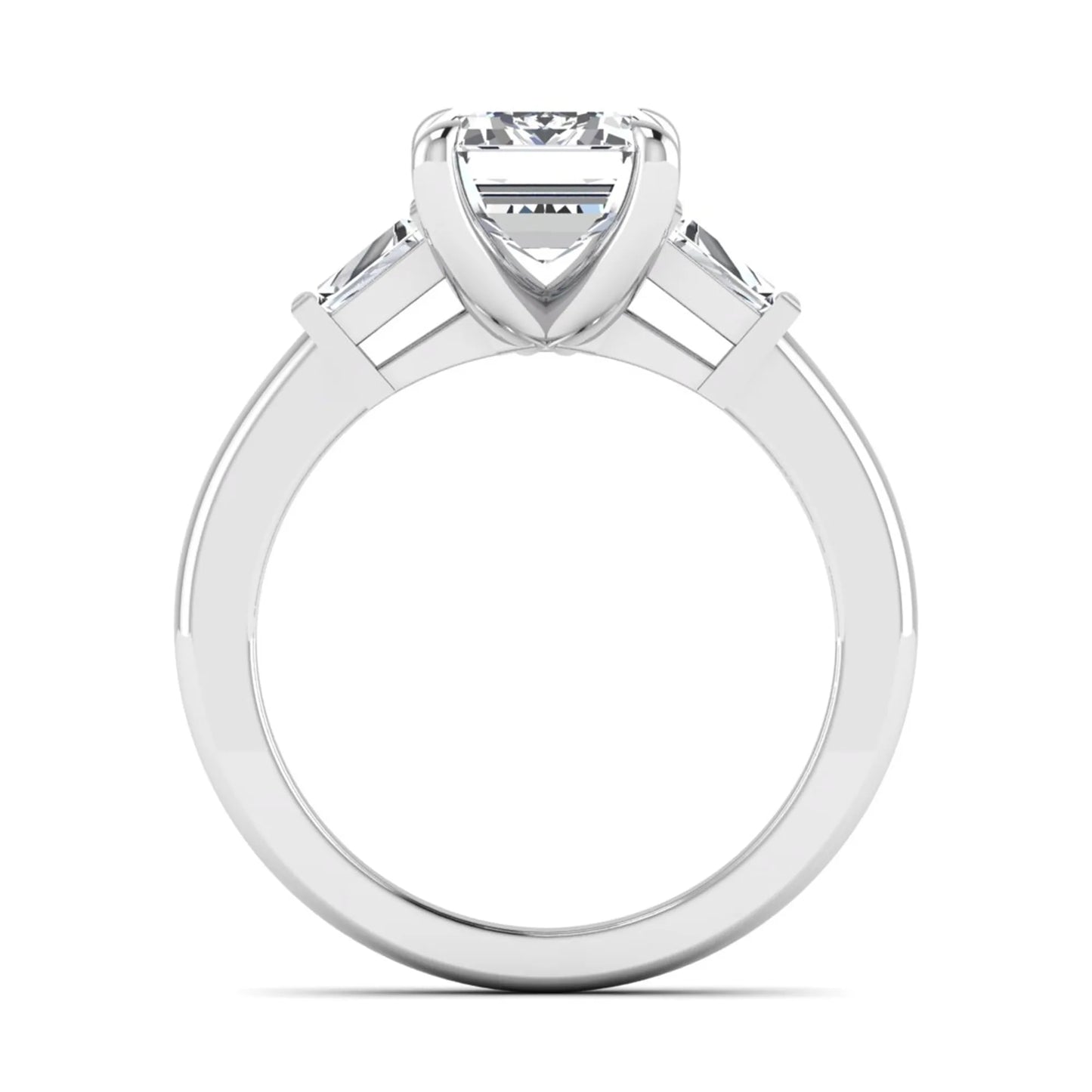 Emerald cut lab grown diamond three-stone engagement ring featuring tapered baguette side diamonds in a classic four-prong white gold style setting.