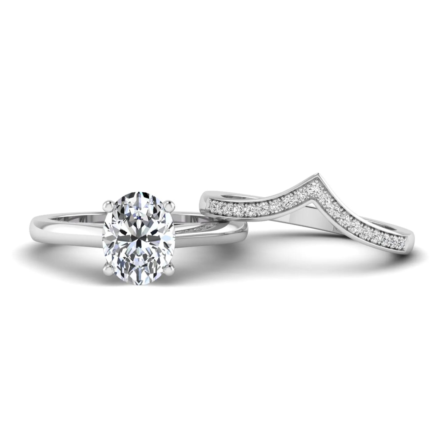 Oval cut lab grown diamond bridal ring set featuring a four-prong solitaire engagement ring with a pavé chevron V-shaped wedding band in a white gold finish.