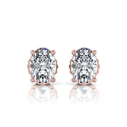 Rose gold earrings with large clear lab grown diamonds on a white background