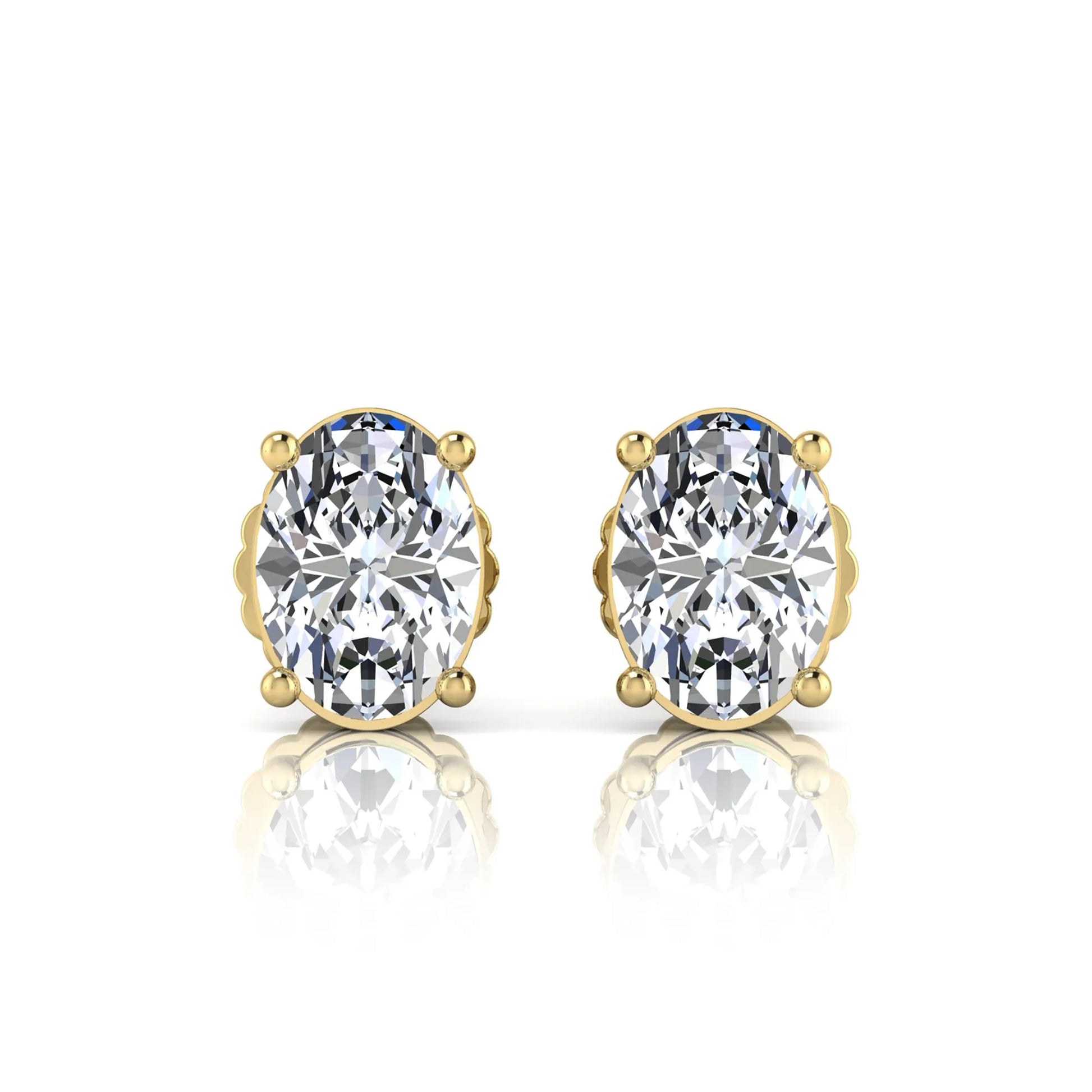 yellow Gold earrings with large clear gemstones on a white background