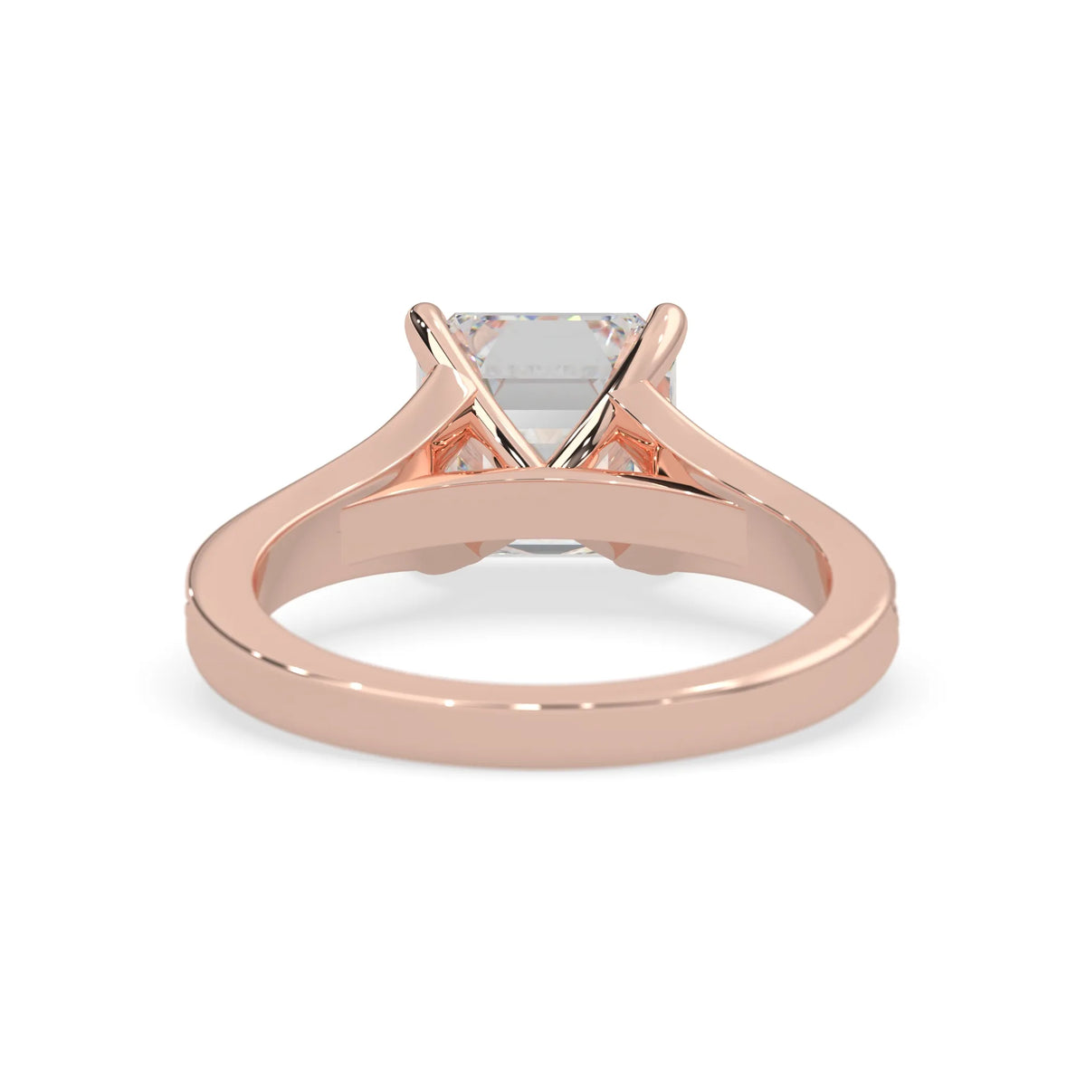 Rose gold ring with a clear gemstone on a white background