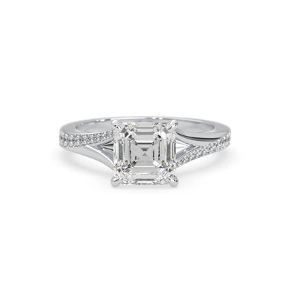 white gold Diamond ring with a central emerald-cut diamond and smaller diamonds on a white background