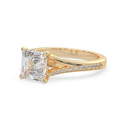 yellow Gold ring with a large diamond and smaller diamonds on the band against a white background