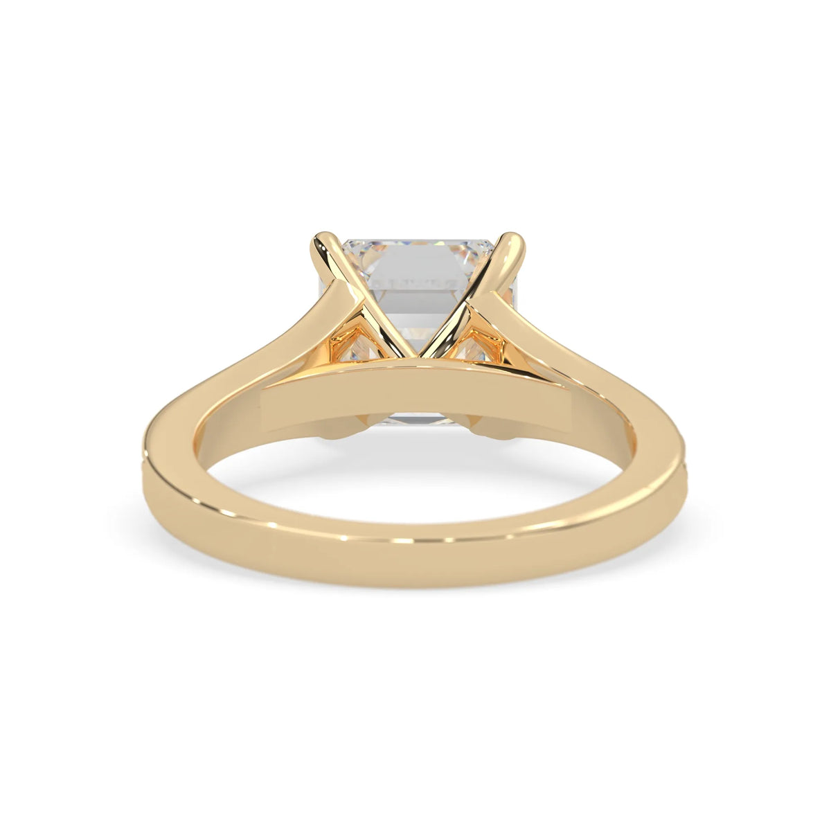 yellow Gold ring with a clear gemstone on a white background