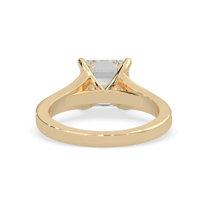 yellow Gold ring with a clear gemstone on a white background