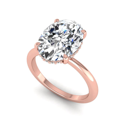 IGI certified oval cut lab grown diamond engagement ring featuring a four-prong setting with a hidden halo of round accent diamonds in rose gold tone.
