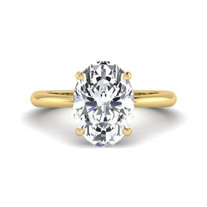 IGI certified oval cut lab grown diamond engagement ring featuring a four-prong setting with a hidden halo of round accent diamonds in yellow  gold tone.