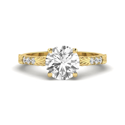 IGI certified round cut lab grown diamond engagement ring with a four-prong setting, vintage leaf-inspired band, and round accent diamonds in yellow gold tone.