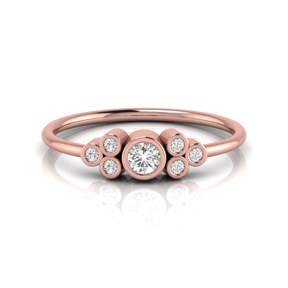 Rose-gold ring with circular diamonds on a white background