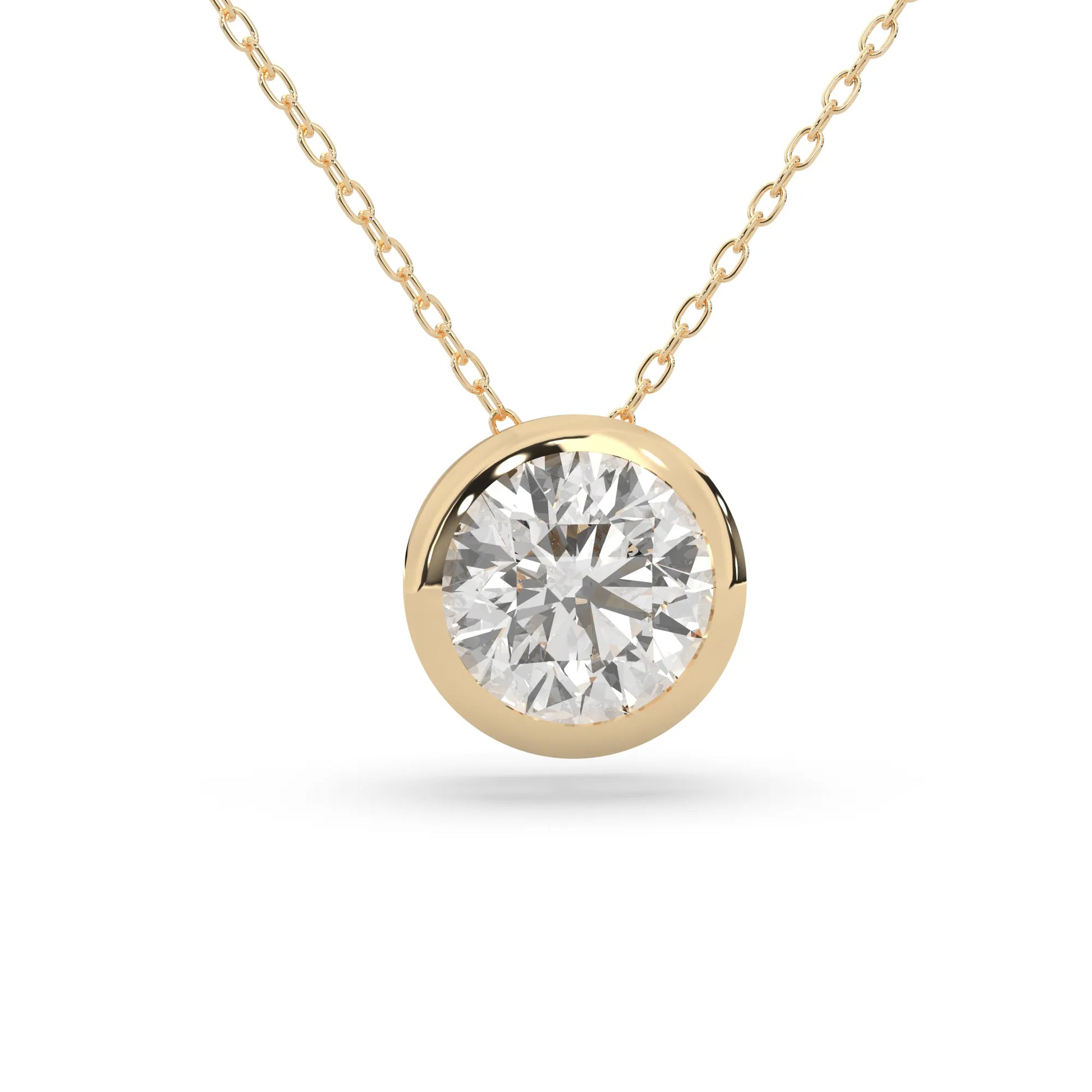 Round brilliant lab grown diamond solitaire pendant necklace in bezel setting with yellow gold tone design and cable chain.