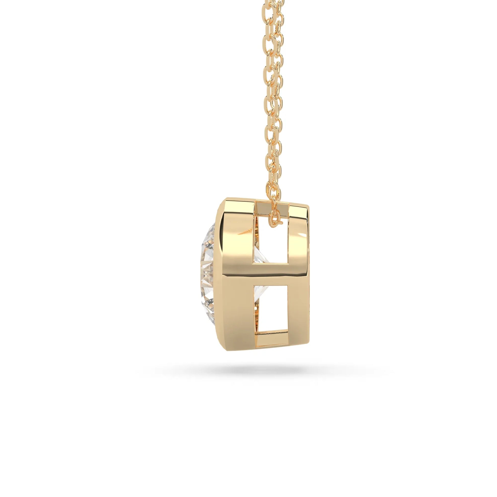 Round brilliant lab grown diamond solitaire pendant necklace in bezel setting with yellow gold tone design and cable chain.