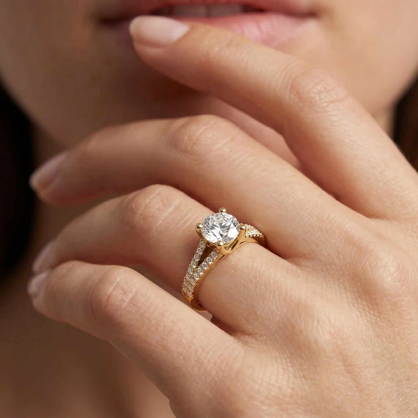 yellow-gold Close-up of a hand wearing a gold ring with a diamond on a blurred background