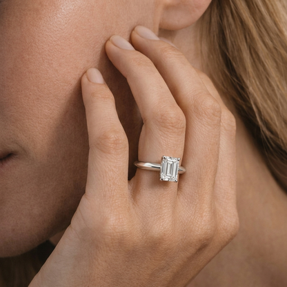 yellow gold Close-up of a hand wearing a diamond ring with a blurred background