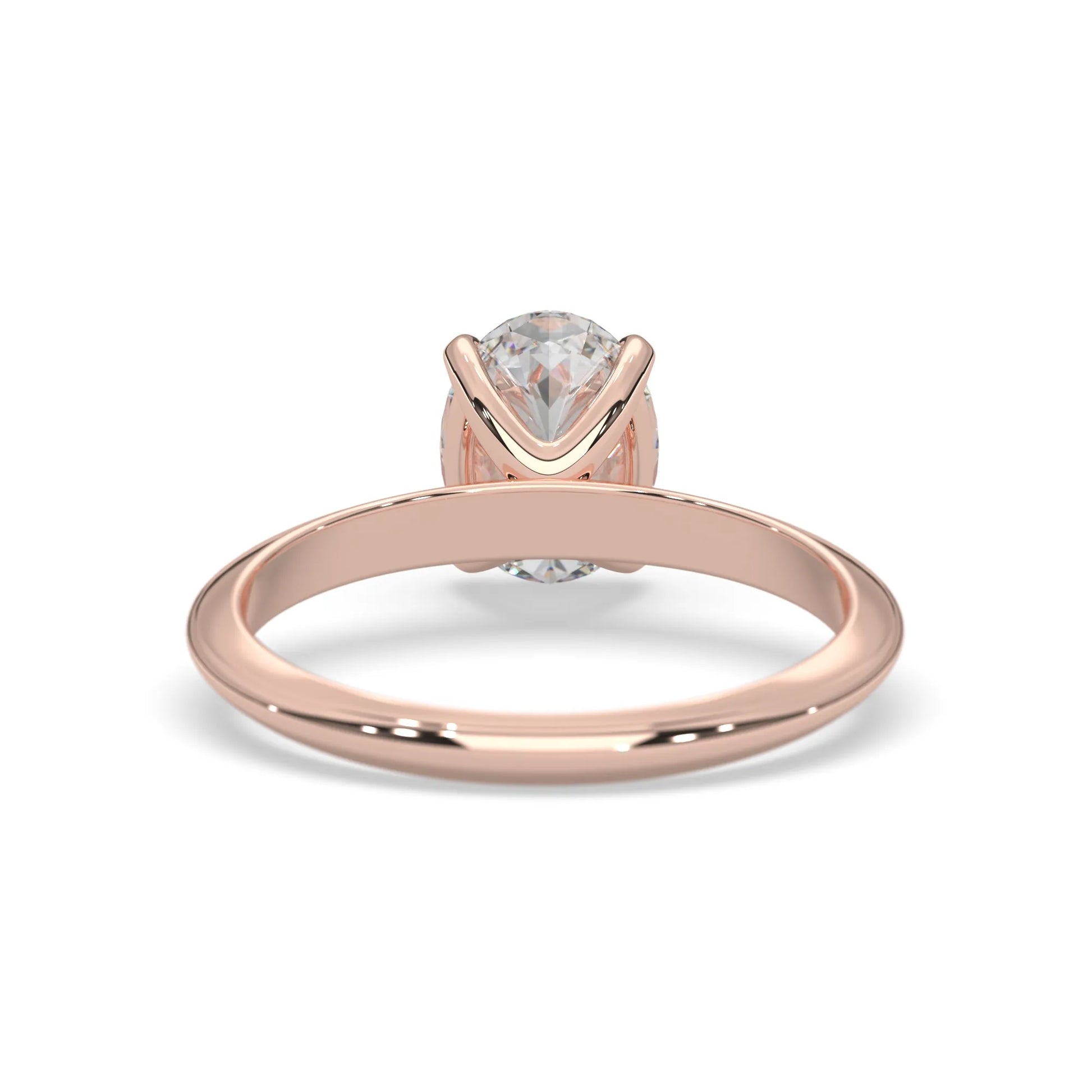 Rose-gold ring with a clear gemstone on a white background