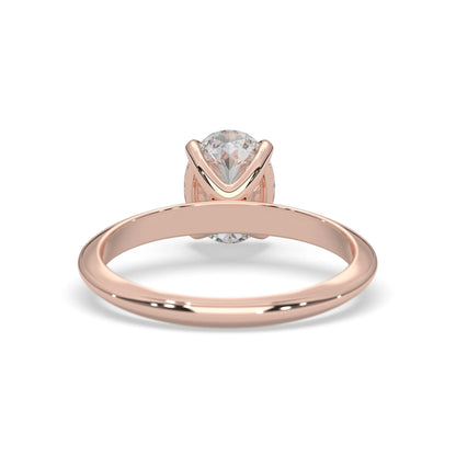 Rose-gold ring with a clear gemstone on a white background