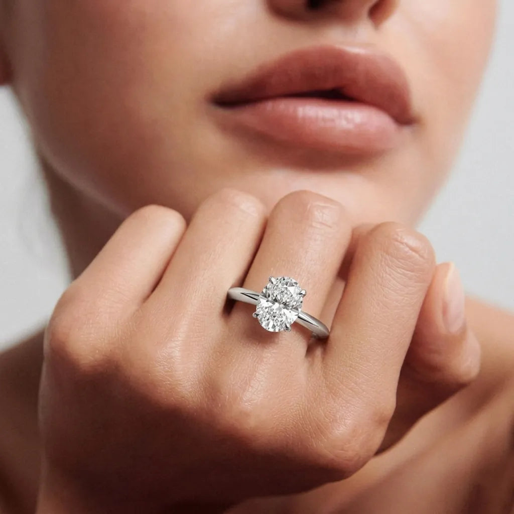 yellow gold  Close-up of a hand wearing a diamond ring with a blurred background