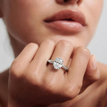 yellow gold  Close-up of a hand wearing a diamond ring with a blurred background