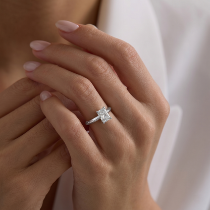 yellow gold Close-up of a hand wearing a diamond ring with a soft background
