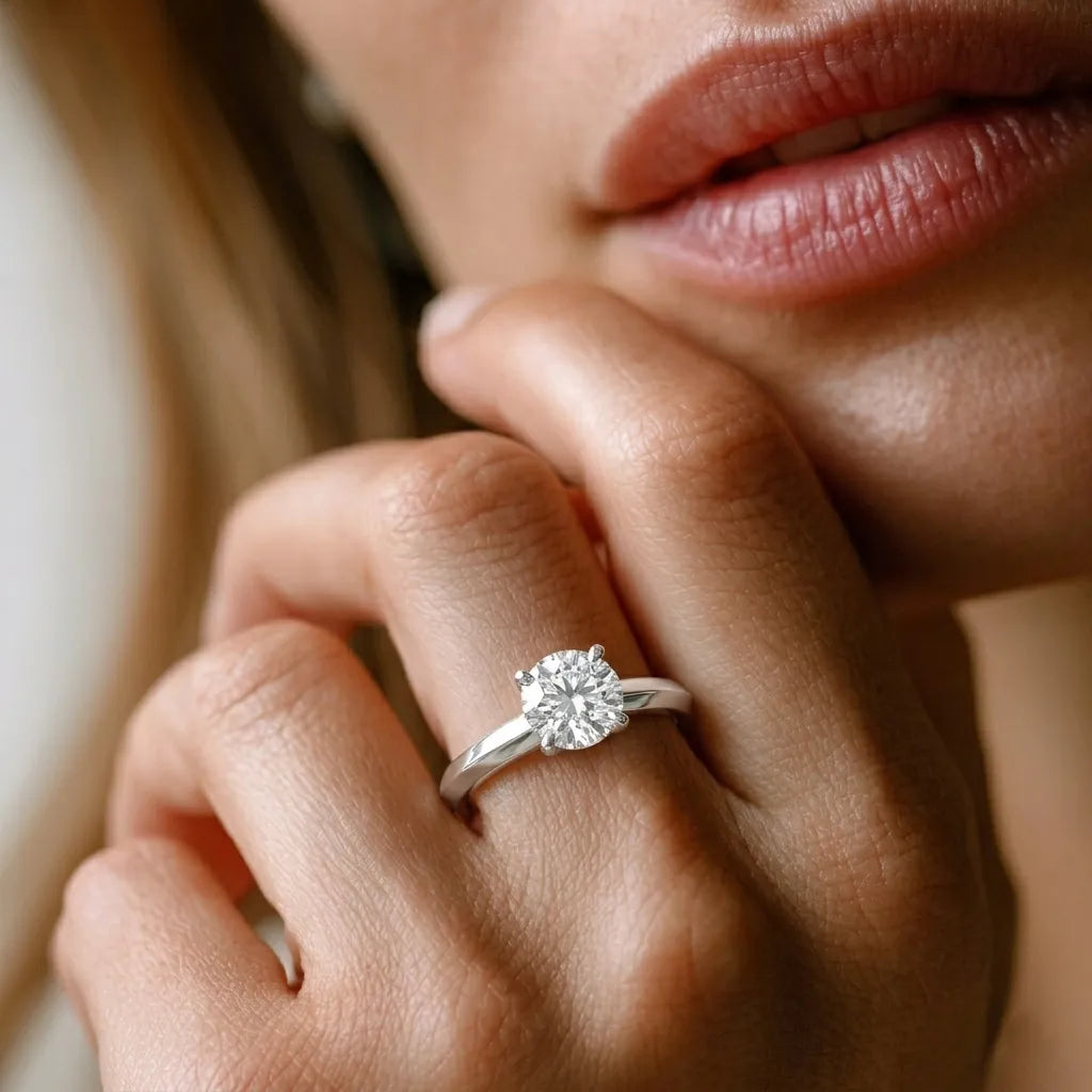 yellow gold Close-up of a hand wearing a diamond ring with a blurred background