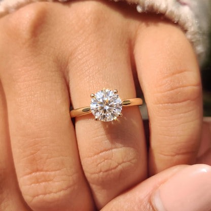 Round lab grown diamond solitaire engagement ring worn on the hand