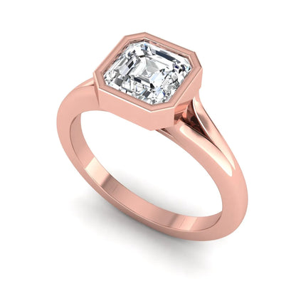 Asscher cut lab grown diamond bezel set split shank engagement ring in rose gold design.