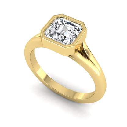 Asscher cut lab grown diamond bezel set split shank engagement ring in yellow gold design.