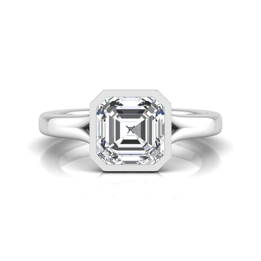 Diamond ring with a rectangular cut gemstone on a white background