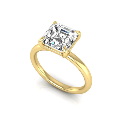 Asscher cut lab grown diamond solitaire engagement ring featuring a classic four-prong setting with a yellow gold tone band.