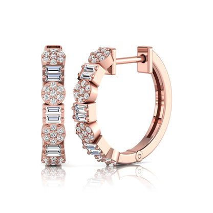 Lab grown diamond huggie hoop earrings featuring alternating baguette cut and round brilliant diamonds with pavé diamond detailing on a rose gold hinged hoop.