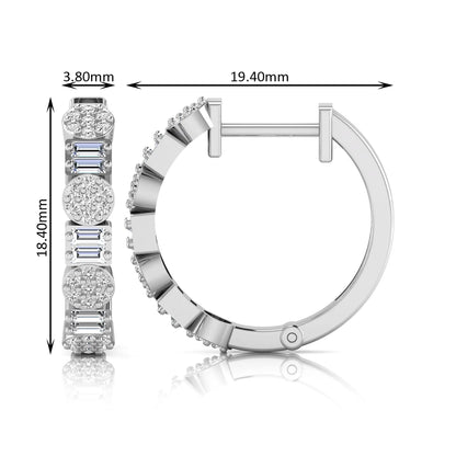 Lab grown diamond huggie hoop earrings featuring alternating baguette cut and round brilliant diamonds with pavé diamond detailing on a white gold hinged hoop.