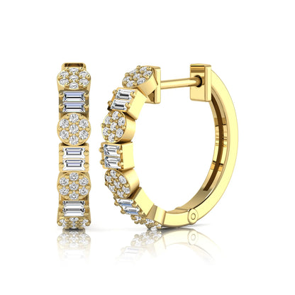 Lab grown diamond huggie hoop earrings featuring alternating baguette cut and round brilliant diamonds with pavé diamond detailing on a yellow gold hinged hoop.