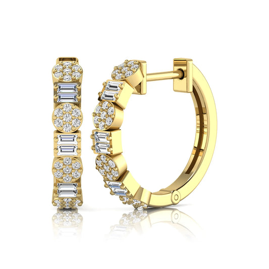 Lab grown diamond huggie hoop earrings featuring alternating baguette cut and round brilliant diamonds with pavé diamond detailing on a yellow gold hinged hoop.