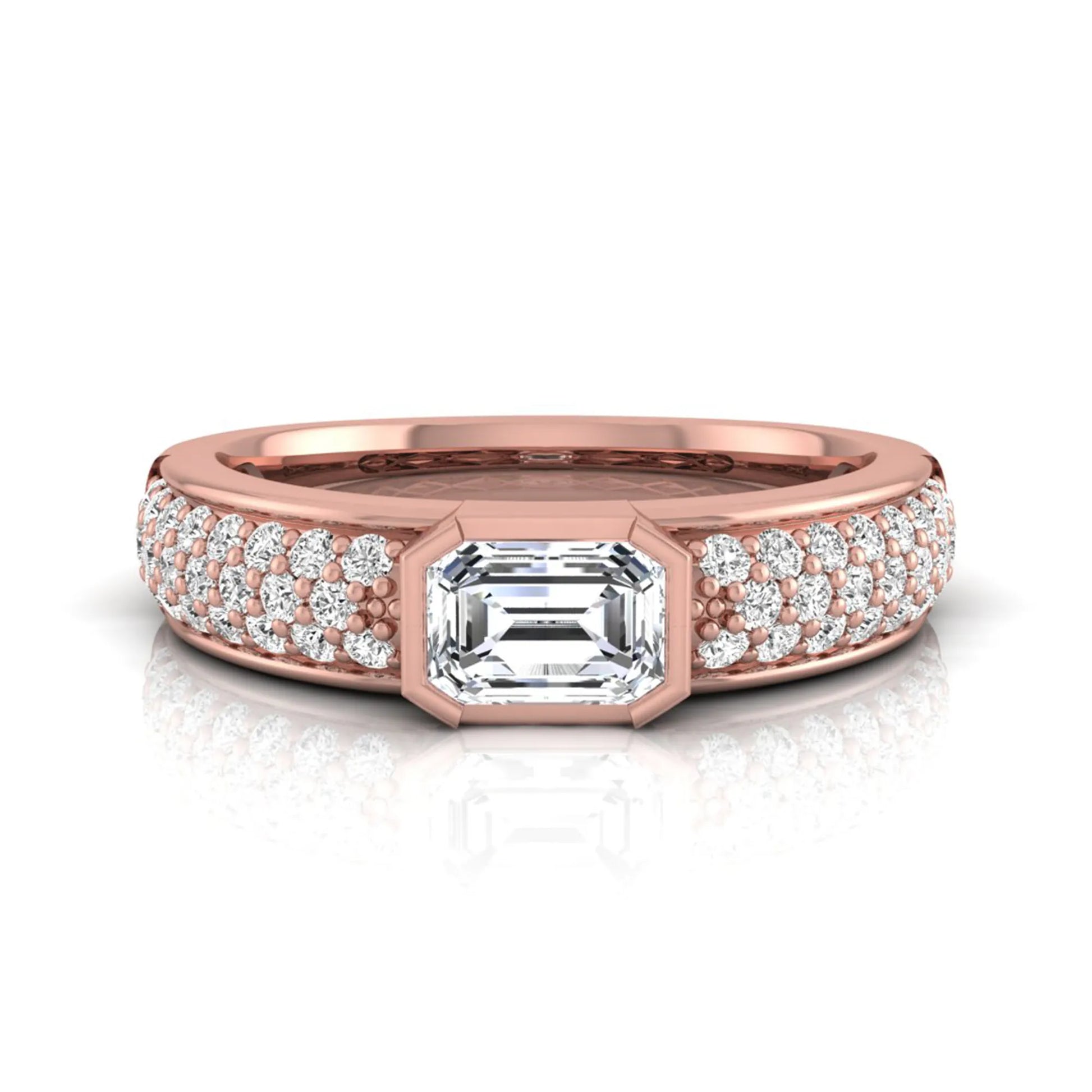 Bezel set emerald cut lab grown diamond engagement ring featuring a 0.52 carat emerald center diamond with pavé round diamond band in rose gold.