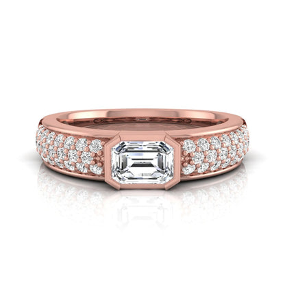Bezel set emerald cut lab grown diamond engagement ring featuring a 0.52 carat emerald center diamond with pavé round diamond band in rose gold.
