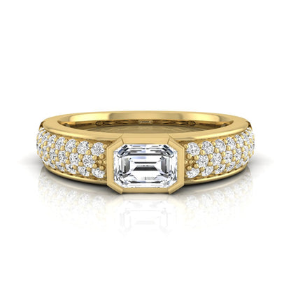 Bezel set emerald cut lab grown diamond engagement ring featuring a 0.52 carat emerald center diamond with pavé round diamond band in yellow gold.