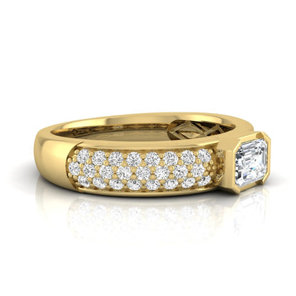 Bezel set emerald cut lab grown diamond engagement ring featuring a 0.52 carat emerald center diamond with pavé round diamond band in yellow gold.