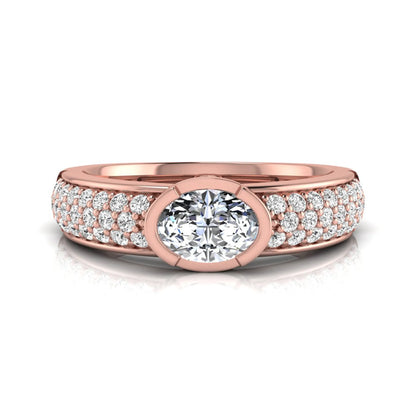 Bezel set oval lab grown diamond engagement ring featuring a 0.52 carat oval center diamond with pavé round diamond band in rose gold.
