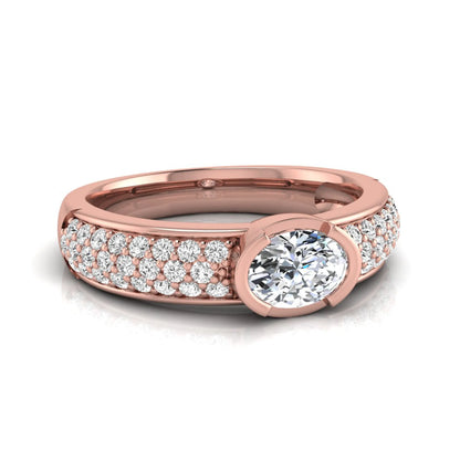 Bezel set oval lab grown diamond engagement ring featuring a 0.52 carat oval center diamond with pavé round diamond band in rose gold.