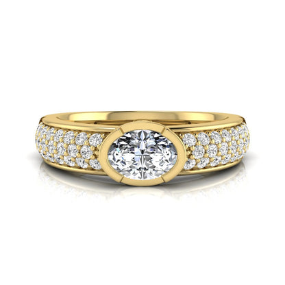 Bezel set oval lab grown diamond engagement ring featuring a 0.52 carat oval center diamond with pavé round diamond band in yellow gold.