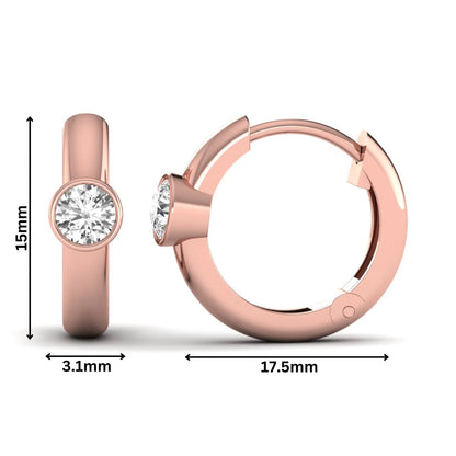 Bezel set round cut lab grown diamond huggie hoop earrings featuring a hinged snap closure and polished rose gold design.