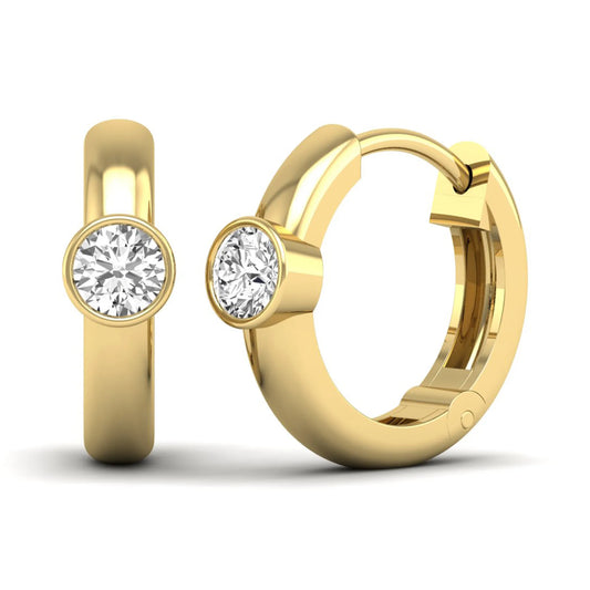 Bezel set round cut lab grown diamond huggie hoop earrings featuring a hinged snap closure and polished yellow gold design.