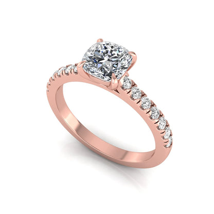 Cushion cut lab grown diamond engagement ring featuring a 1.03 carat center diamond in a four-prong setting with round accent diamonds on a rose gold design.