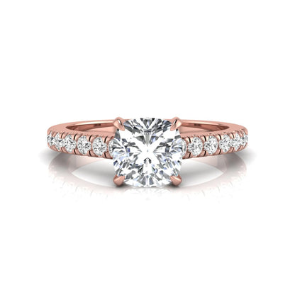 Cushion cut lab grown diamond engagement ring featuring a 1.03 carat center diamond in a four-prong setting with round accent diamonds on a rose gold design.