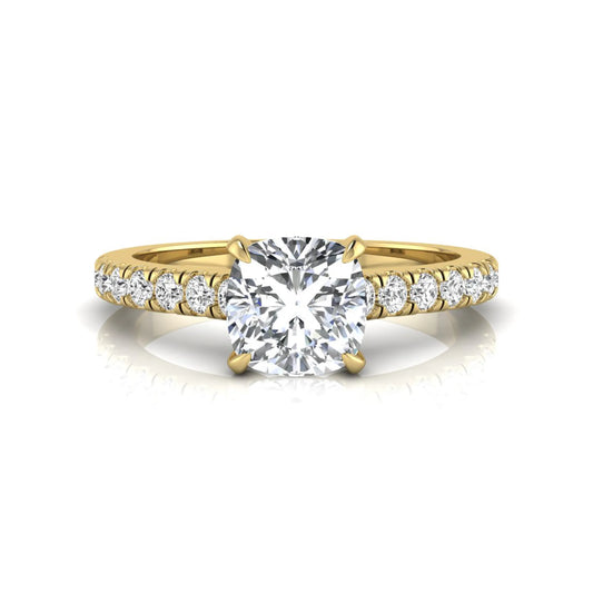 Cushion cut lab grown diamond engagement ring featuring a 1.03 carat center diamond in a four-prong setting with round accent diamonds on a yellow gold design.