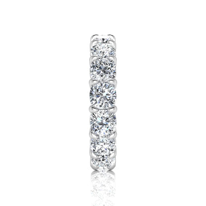 Cushion cut lab grown diamond eternity band ring featuring shared prong set diamonds with a white gold tone design.