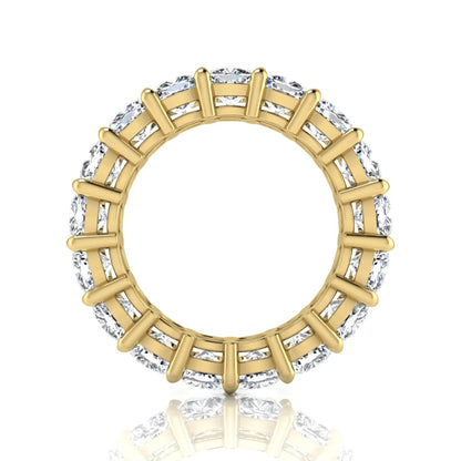 Cushion cut lab grown diamond eternity band ring featuring shared prong set diamonds with a yellow gold tone design.
